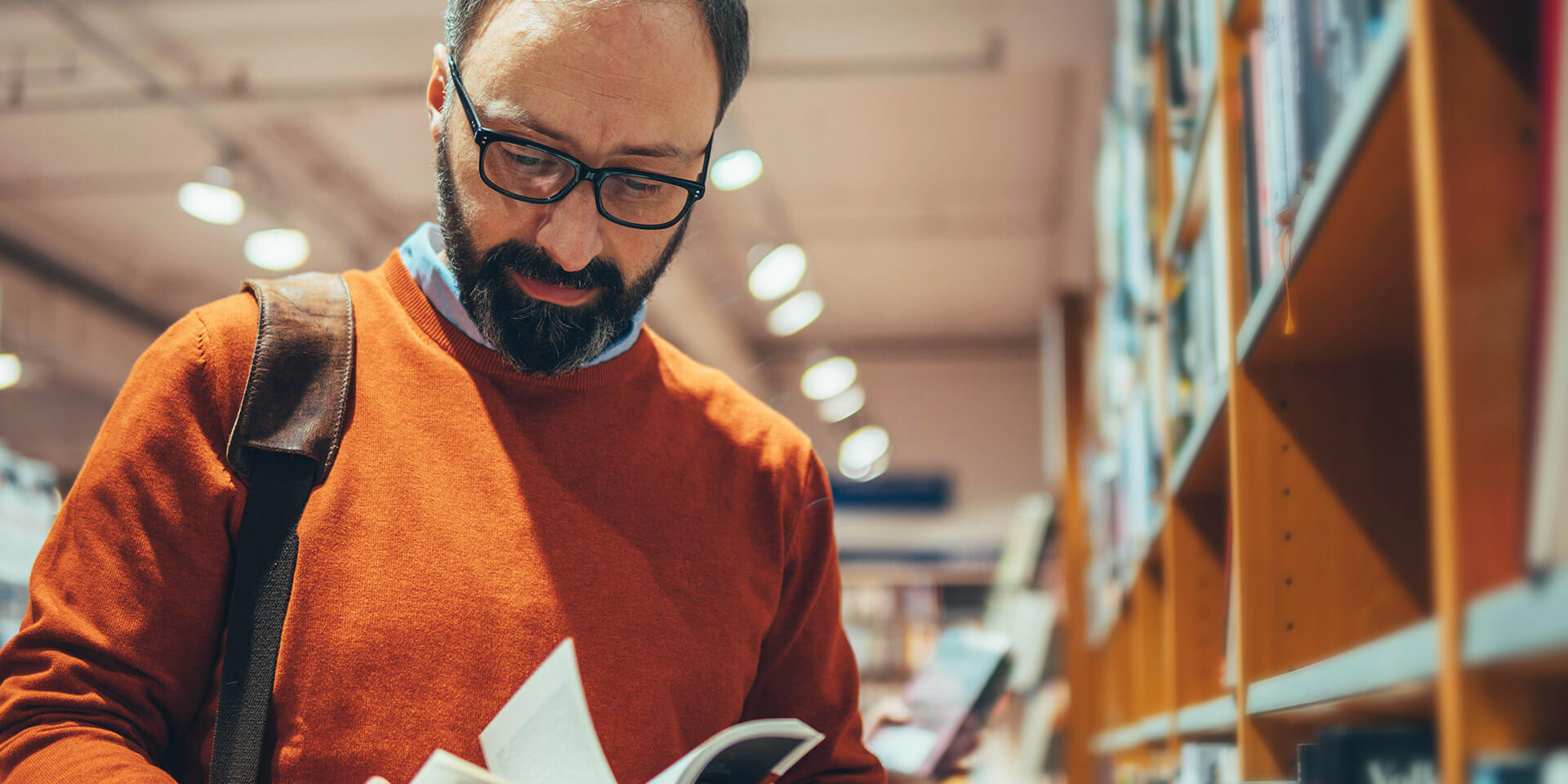 Mann vor Bücherregal Bücherei